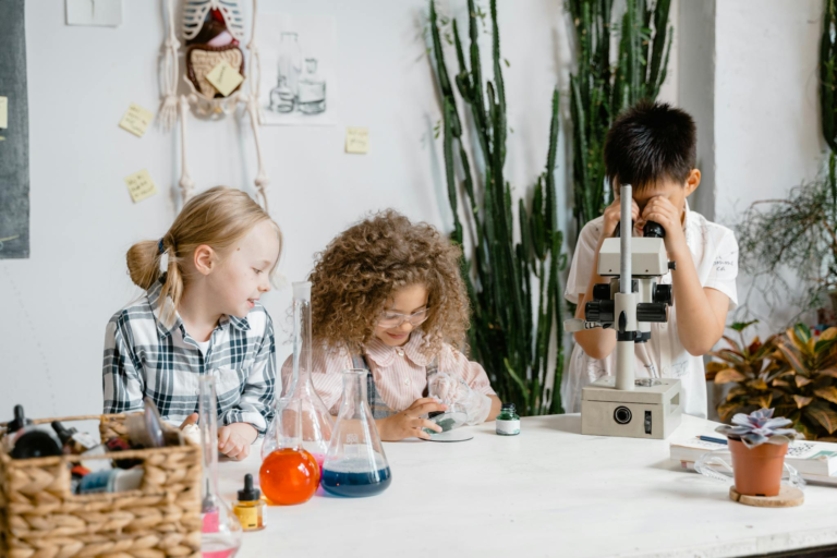 Diverse group of children engaged in science experiments in a classroom laboratory setting.